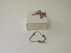 Pandora charm bracelet with 5 charms. Estimate £30-50.