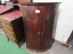 Mahogany bow front corner cupboard with double doors, 70cms x 49cms x 104cms.