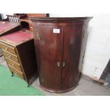 Mahogany bow front corner cupboard with double doors, 70cms x 49cms x 104cms.