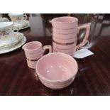 Sadler pink ironstone creamer, milk jug & sugar bowl. Estimate £25-35.