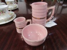 Sadler pink ironstone creamer, milk jug & sugar bowl. Estimate £25-35.