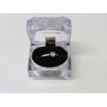 18ct gold lady's solitaire diamond ring with raised platinum shoulders. Estimate £130-150.