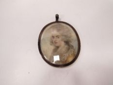 Miniature watercolour portrait of a young lady in period costume with lock of hair to reverse.