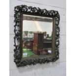 Bevel edge mirror in highly ornate carved foliage frame, approx 90cms x 82cms. Estimate £100-120.