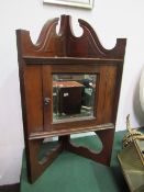 Small dark oak corner wall cupboard with mirrored door. Estimate £20-30.