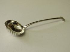 Silver ladle with scalloped decoration, London 1895, wt 2.65ozt. Estimate £20-30.