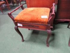 Piano stool with rising lid. Estimate £20-30.