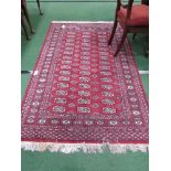 Red ground patterned Bokara runner, 187 x 122. Estimate £30-40.