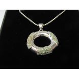 Silver necklace & hoop pendant set with green stones. Estimate £10-20.