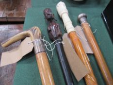 4 various walking sticks including 1 with silver ferrule. Estimate £10-20.