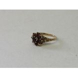 9ct gold garnet cluster ring, size K. Estimate £25-35.