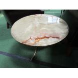 Circular onyx top on brass base side table, 60cms diameter. Estimate £30-40.