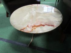 Circular onyx top on brass base side table, 60cms diameter. Estimate £30-40.