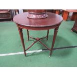 Circular mahogany table on tapered legs to castors, diameter 76cms. Estimate £10-20.
