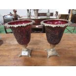 Pair of red glass & brass decorative urns, height 35cms, diameter 26cms. Estimate £30-50.