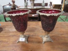 Pair of red glass & brass decorative urns, height 35cms, diameter 26cms. Estimate £30-50.