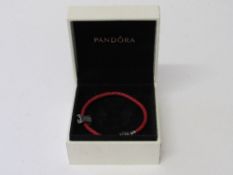 Original Pandora leather twist bracelet with moulded figure & clasp. Estimate £15-20.