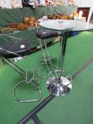 Tall glass circular table with 2 chrome & leather high stools, height 100cms. Estimate £40-60.