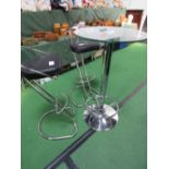 Tall glass circular table with 2 chrome & leather high stools, height 100cms. Estimate £40-60.