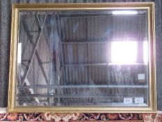 Gilt framed bevel edge mirror, 87cms x 112cms. Estimate £40-60.