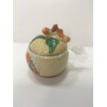 Clarice Cliff 'Bizarre' hand painted crocus jam pot with lid. Estimate £10-20.