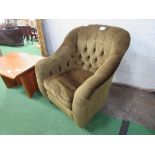 Dark green button back armchair on castors. Estimate £15-20.