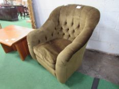 Dark green button back armchair on castors. Estimate £15-20.