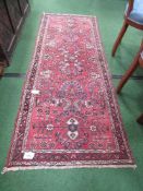 Red ground patterned runner, 214 x 84. Estimate £10-20.