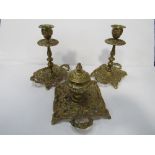Ornate brass inkwell with matching candle holders. Estimate £20-30.