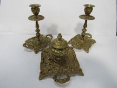 Ornate brass inkwell with matching candle holders. Estimate £20-30.