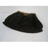 Lady's Art Deco black & gold beaded evening bag with gold plated frame & strap & contrast beading at