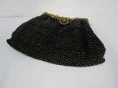 Lady's Art Deco black & gold beaded evening bag with gold plated frame & strap & contrast beading at