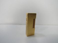 Authentic Dunhill gold rollagas lighter, Swiss made with Code RE24153. Estimate £50-80.