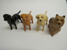 4 Beswick dogs: Black Labrador, 2 Gold Labradors & a Yorkshire Terrier