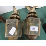 Pair of brass carriage lamps with eagle mounts (1 with 2 cracked panes of glass). Estimate £40-50.