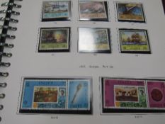 4 various stamp albums & a tin containing stamps. Estimate £10-20.