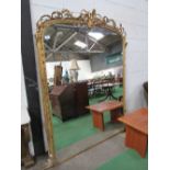 Very large arched top gilt framed wall mirror with decorated foliage to top, 220cms x 164cms.