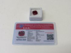 Natural red cushion cut ruby, 10.5 carat, with certificate. Estimate £50-70.