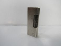 Authentic Dunhill silver rollagas lighter, Swiss made with Code 13373. Estimate £40-60.