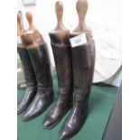 Pair of vintage black leather riding boots with period wooden trees. Estimate £30-50.