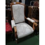 French walnut upholstered open arm chair with castors. Estimate £30-40.