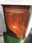 Oak corner cupboard with shaped interior shelves, 77cms x 104cms. Estimate £40-50.