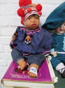 The Collectors’ Encyclopaedia of Dolls by Coleman & a Mongol tribe doll. Estimate £10-20.