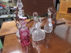 3 cut glass decanters, cut glass claret jug & a ruby coloured cut glass decanter, a/f. Estimate £