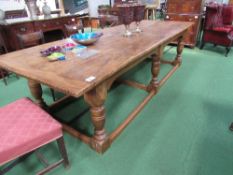 Large elm dining table on heavy bulbous legs with stretchers to floor with clenched ends, 305cms x