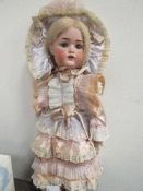 A large A.M. bisque German doll, circa 1930's, a/f, approx 72cms height. Estimate £60-80.