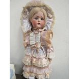 A large A.M. bisque German doll, circa 1930's, a/f, approx 72cms height. Estimate £60-80.