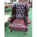 Leather 2 seat button back sofa & 2 button back winged armchairs. Estimate £150-180.