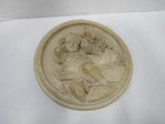 Putti circular plaque signed E W Wyon & 1 other, not signed. Estimate £60-80.