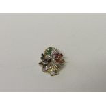 18ct gold floral brooch with blue, green & red stones & diamonds. Estimate £50-70.